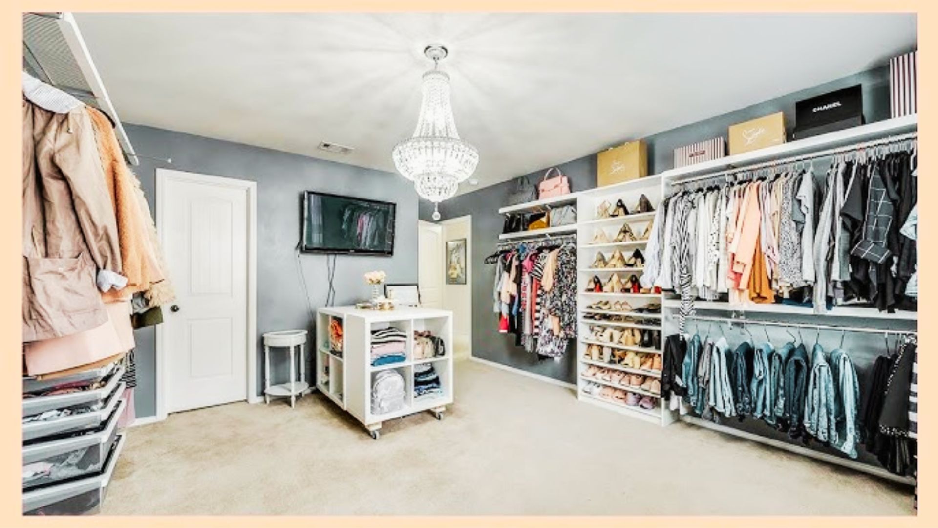 Bright spare room converted to a closet featuring a central island, large mirror, and window views.