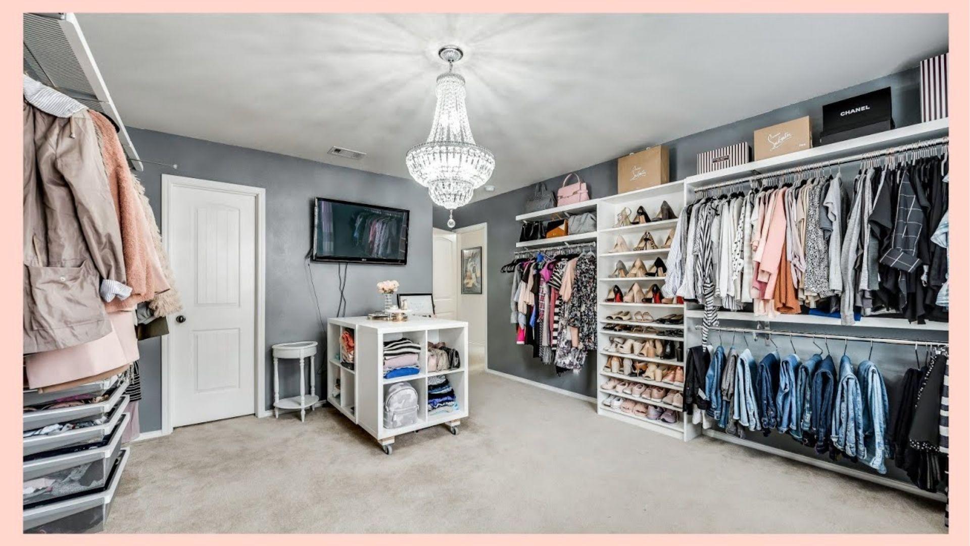Spacious bedroom converted to walk-in closet with wall racks and shoe shelves. Use cube storage and chandeliers for budget glam.