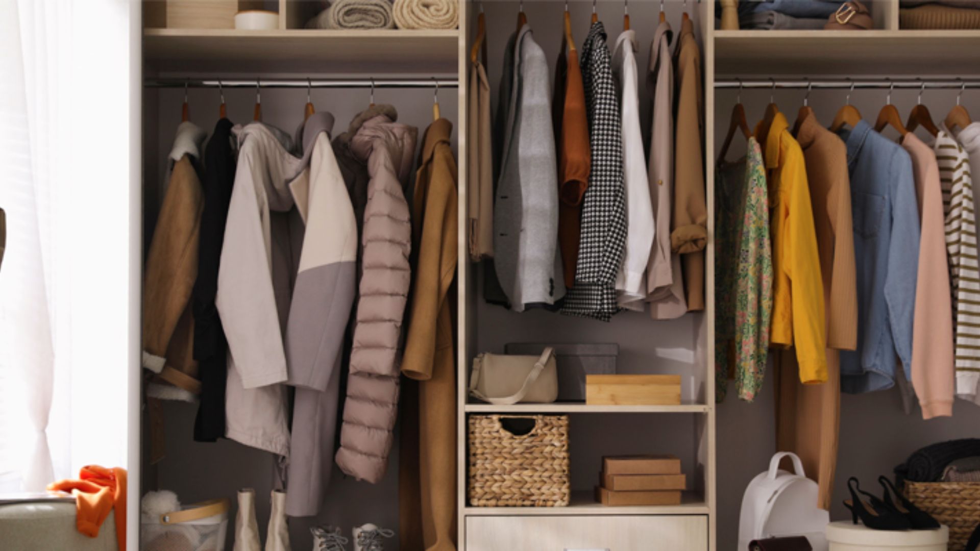 Walk-in closet with three sections of single hanging rods set at standard long-hang height.