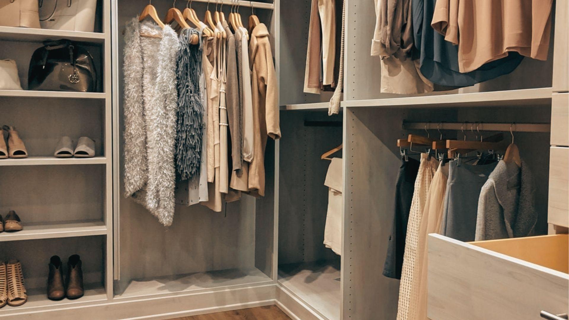 Custom wood closet with deep 20-inch shelves for bulky sweaters and bags beside hanging rods.
