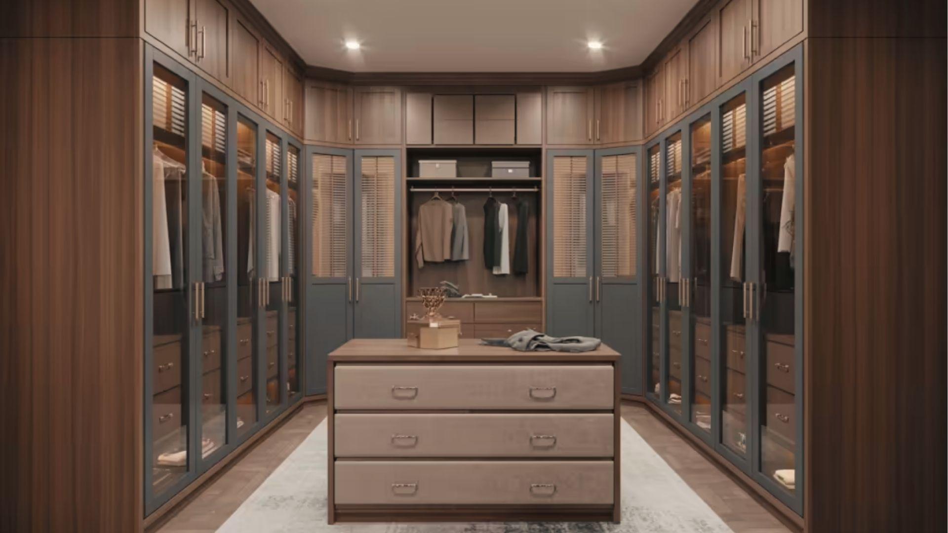 Spacious U-shaped walk-in closet with center island, glass cabinets, and warm ceiling lights.