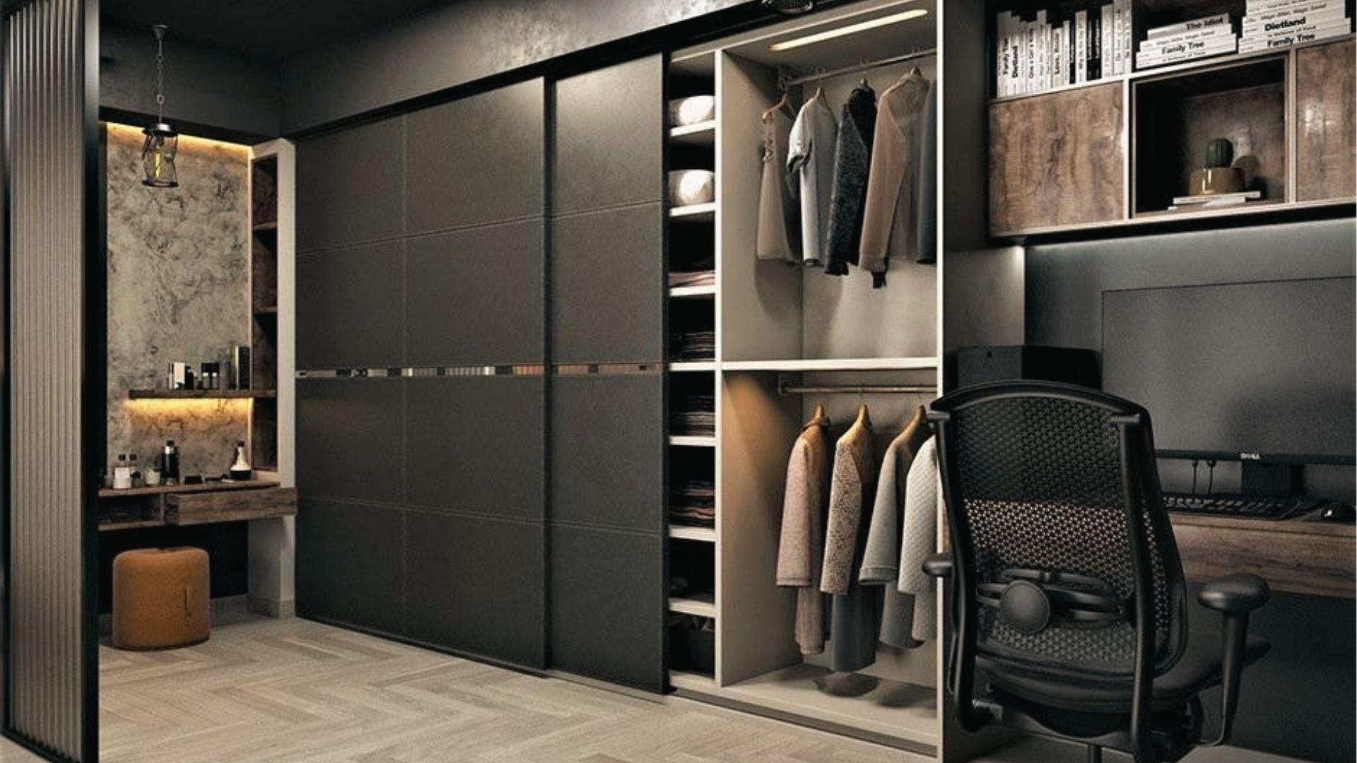 Modern dark bedroom closet combo with sliding doors, desk, office chair, and built-in vanity space.