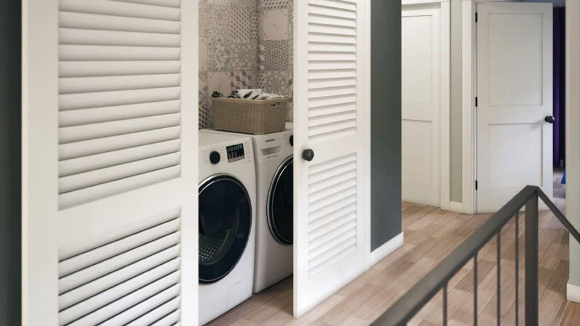 White louvered bypass doors hide the laundry closet, a ventilated bifold door alternative.
