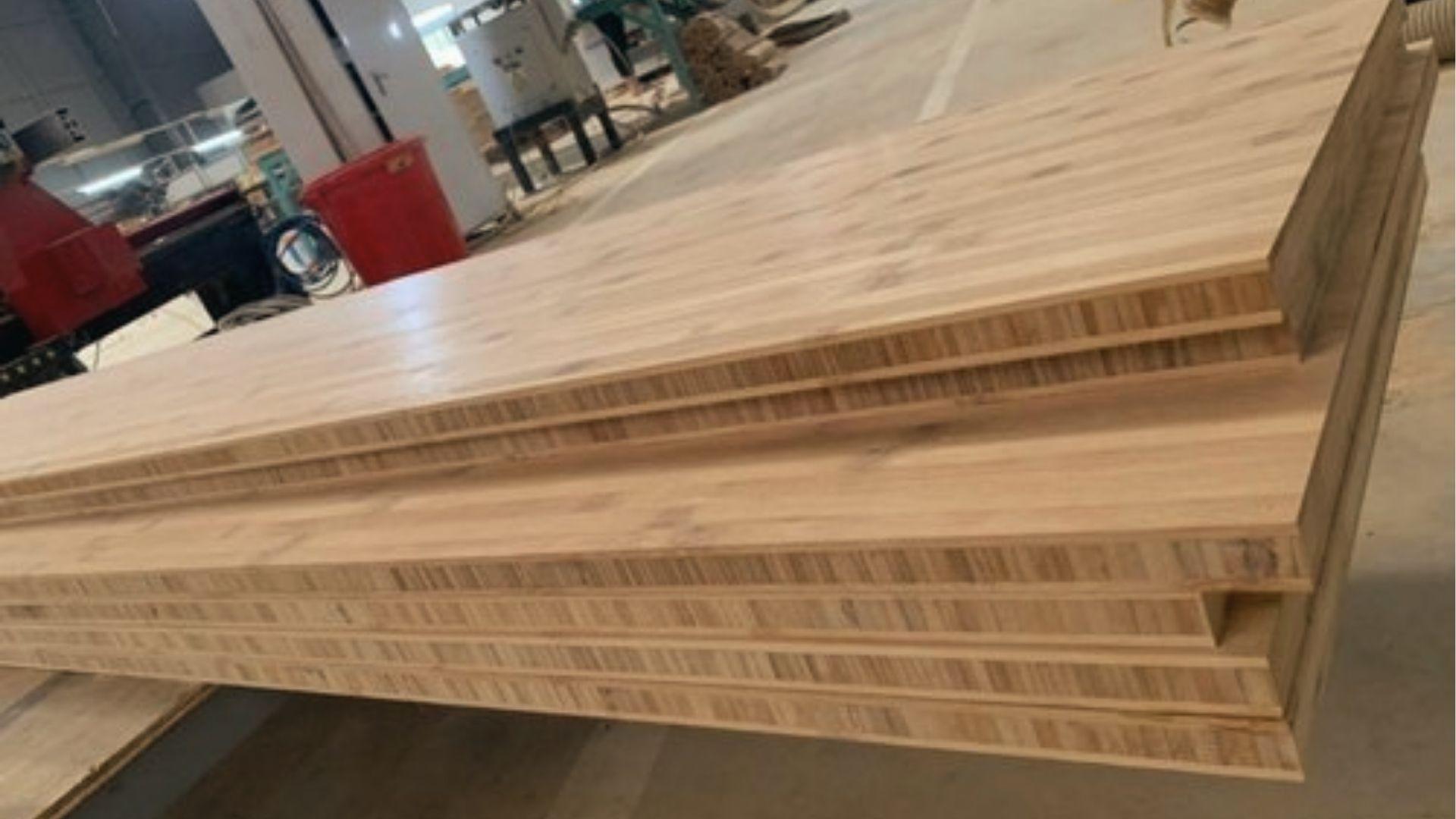 Bamboo plywood panels in the workshop, eco-friendly strong wood option for modern closet shelves.