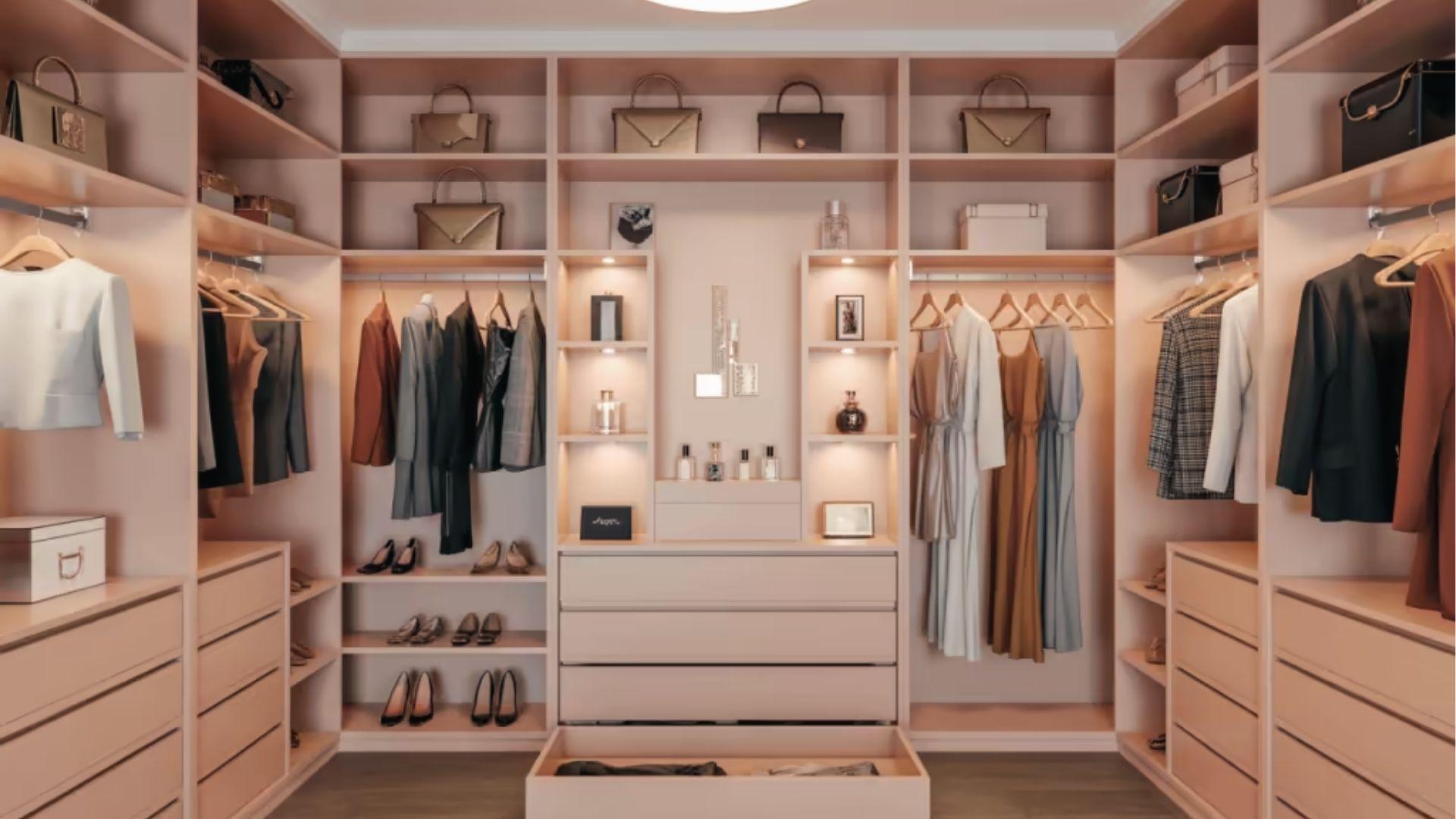 Blush pink walk-in closet with full shelving, drawers, handbag displays, and LED accent lighting.