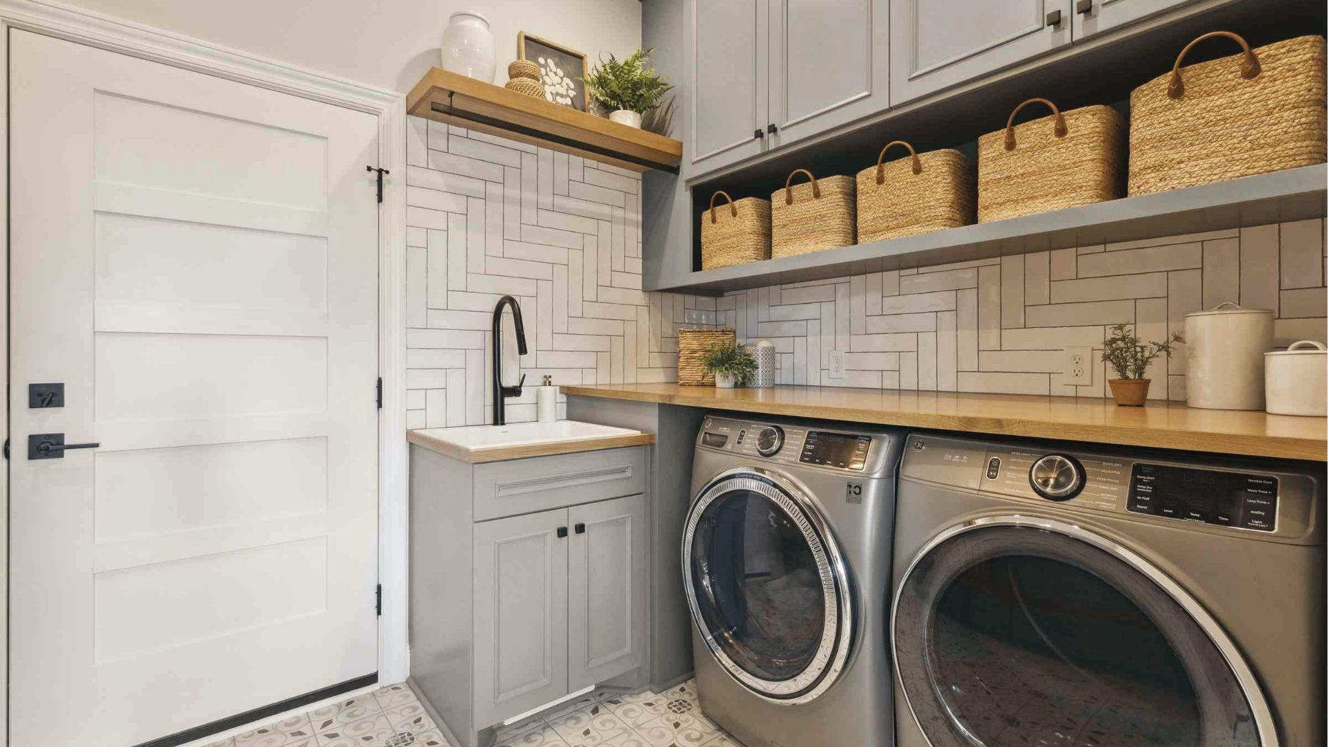 The standard white swing door replaces bifold doors for the laundry room with gray cabinets.