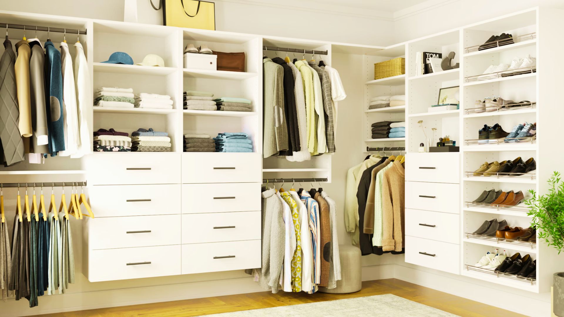 Bright U-shaped walk-in closet with light wood cabinets, hanging clothes, shoes, plants, and bench.