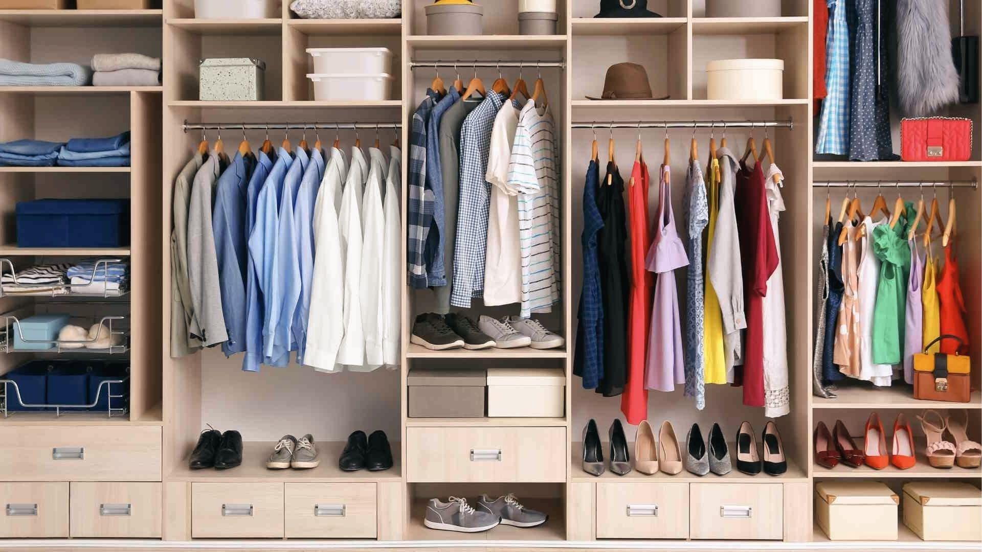 Organized walk-in closet layout with color-coded clothes, shoes, drawers, and storage boxes.